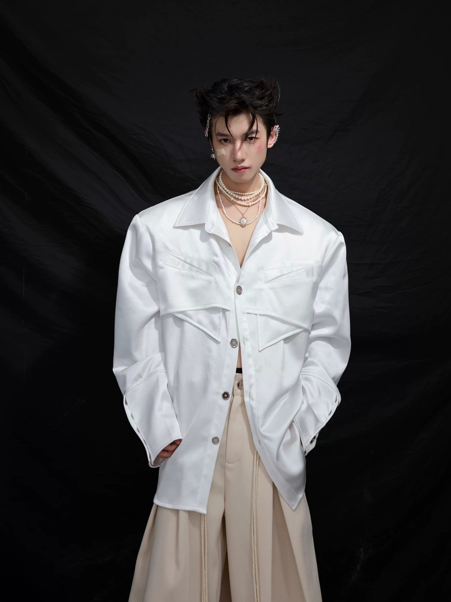 Close-up of the detachable shoulder pads and pleated design details.