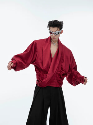 Model wearing a red liquid texture oversized shirt in a street setting