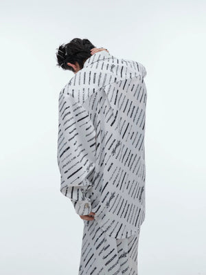 Close-up of deconstructed tie and shirt collar on silk loungewear.