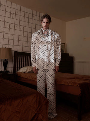 Couple wearing matching black and white silk luxury loungewear sets.