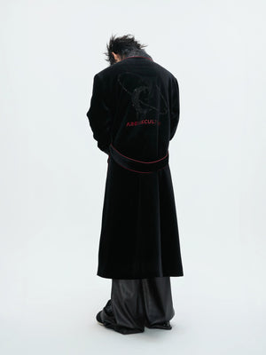 Model wearing luxury velvet robe in a modern home setting