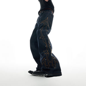 Close-up back view of vintage flare jeans showing unique pocket design with red contrast stitching