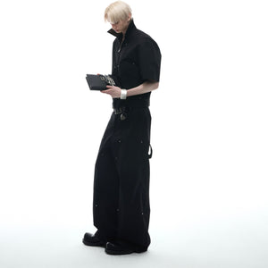 Model wearing asymmetric deconstructed tee with studded cargo pants set from side angle