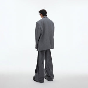 Stylish combination of deconstructed blazer and relaxed trousers for fashion-forward urban wear