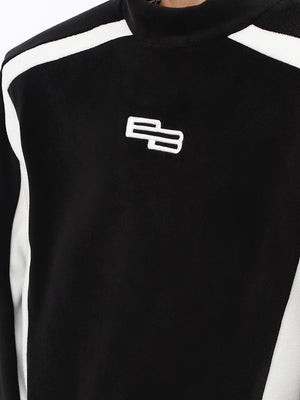 Side profile showing bold panel construction of high-fashion black and white contrast unisex hoodie