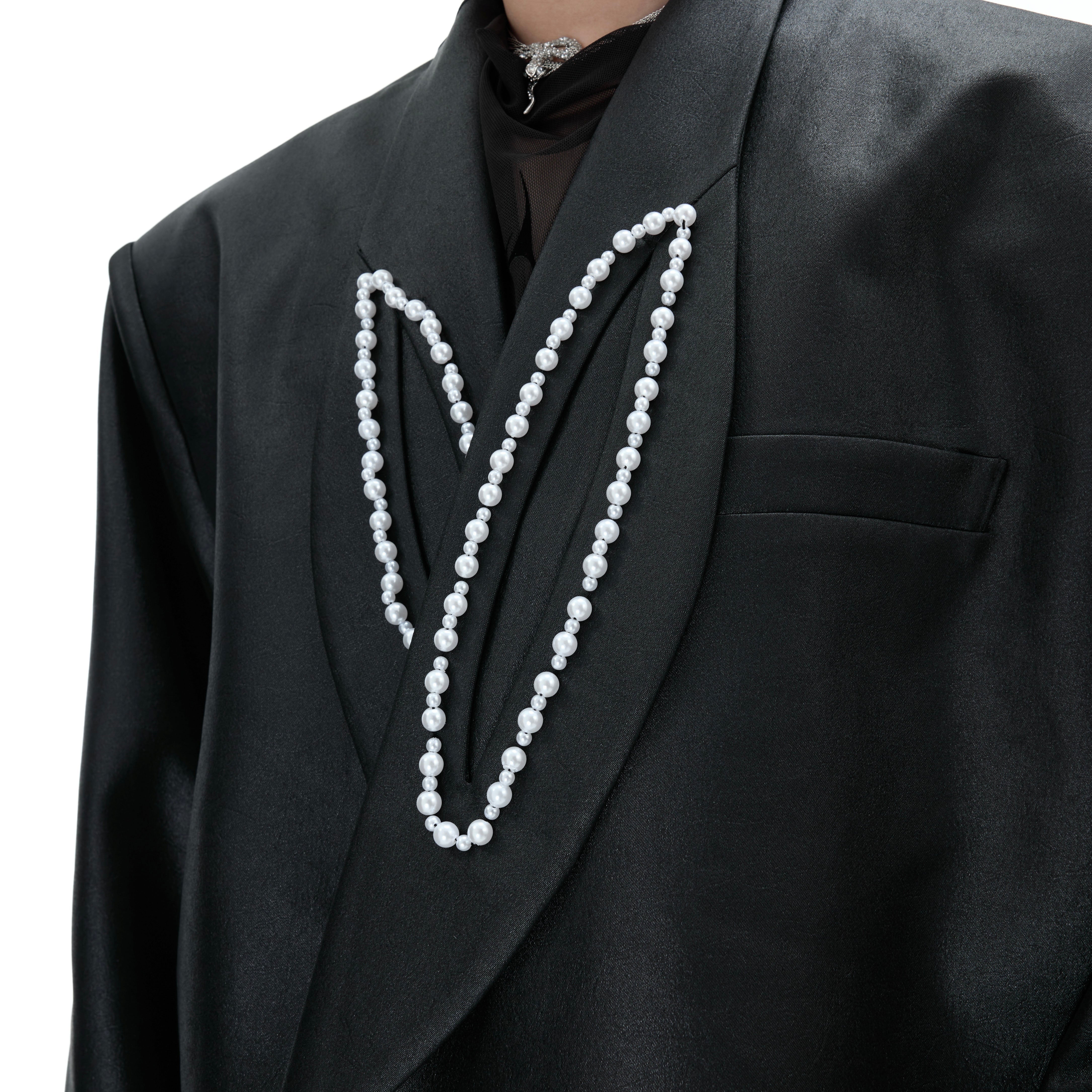 Close-up of the premium blended fabric and elegant peak lapel on this pearl-detailed streetwear blazer