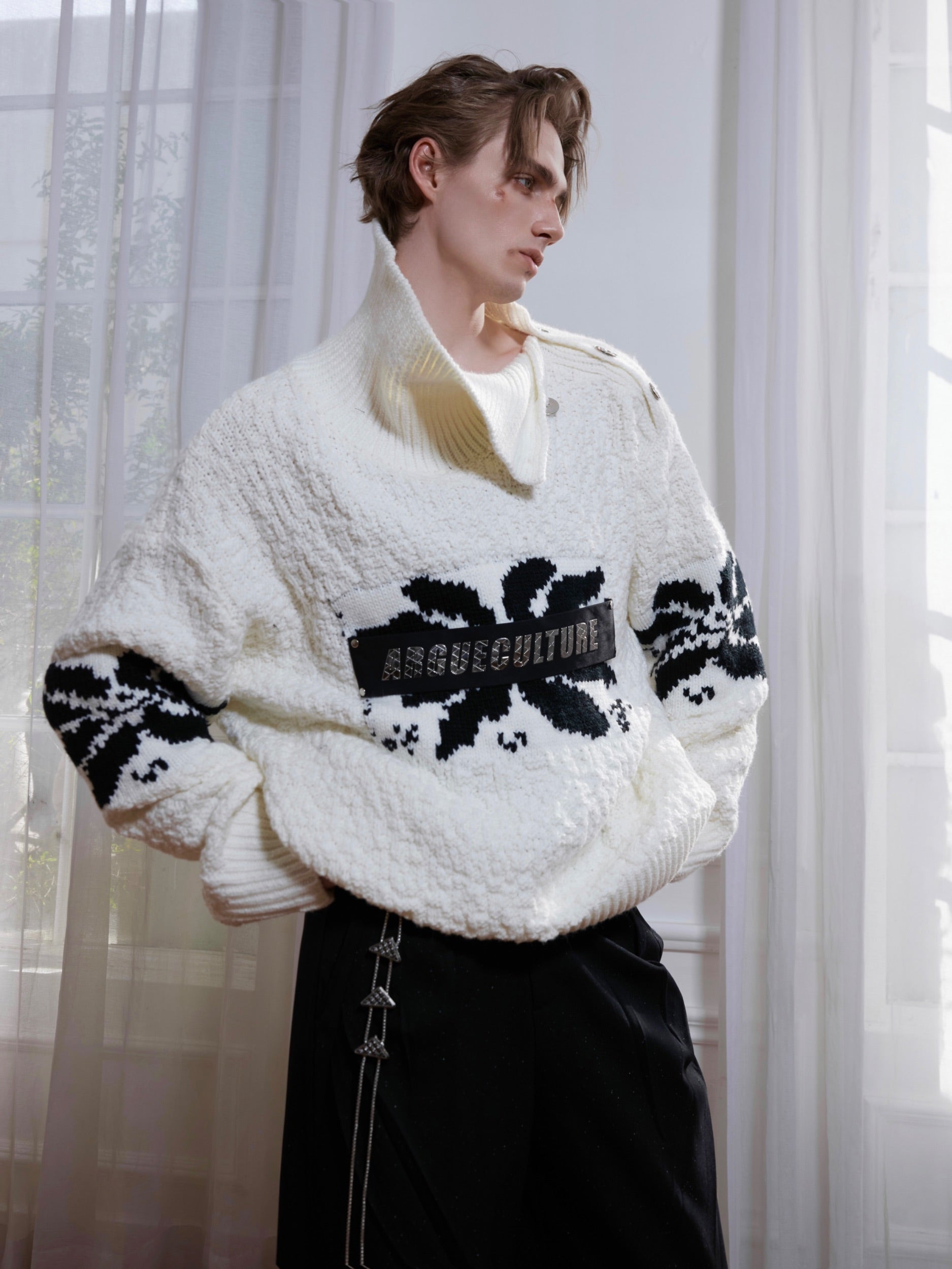 Front view of oversized chunky knit sweater with high neck and decorative metal buttons, perfect for streetwear looks