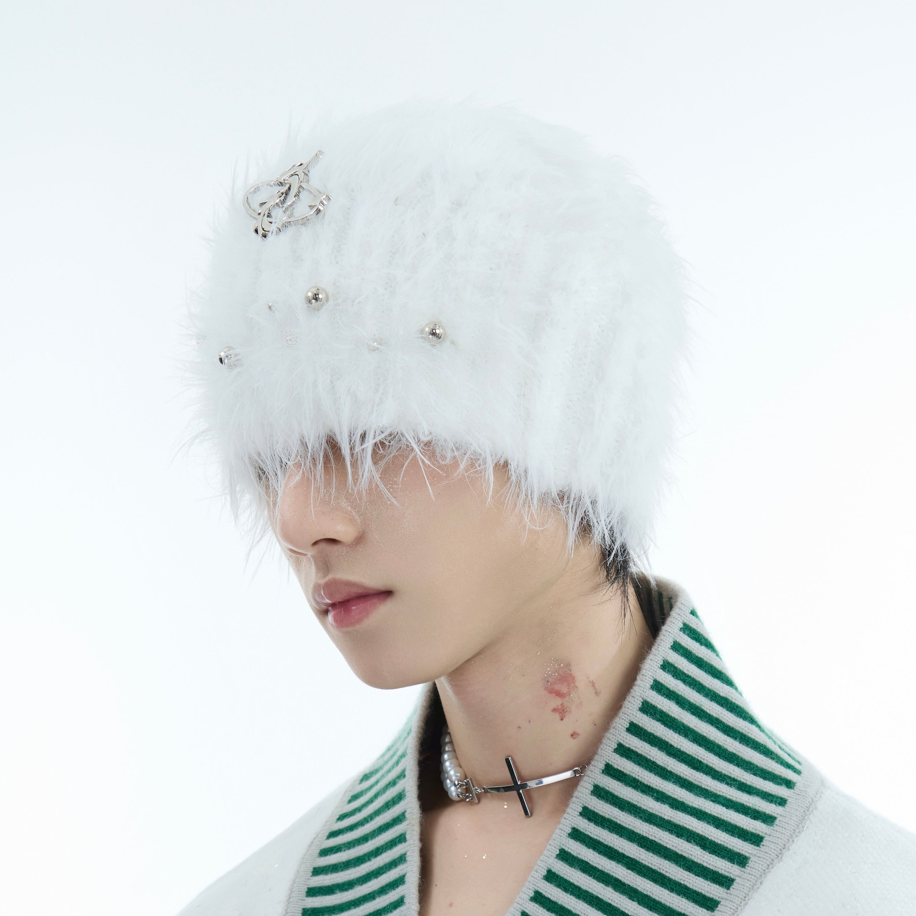 Woman modeling the thick knitted beanie, demonstrating how the pearl accents complement winter outfits