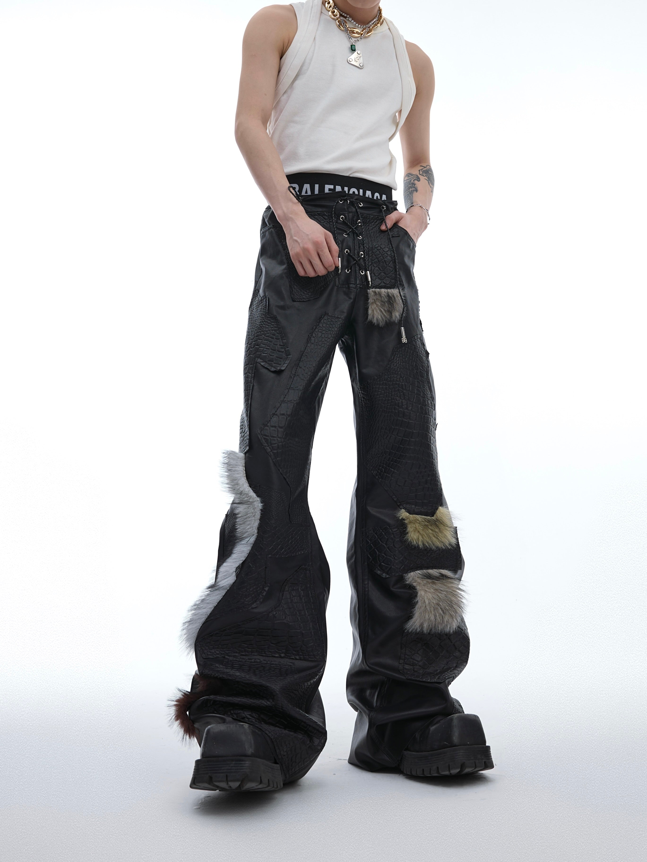 Edgy cracked leather punk pants with skinny flare cut, featuring 3D irregular pleats for avant-garde street style