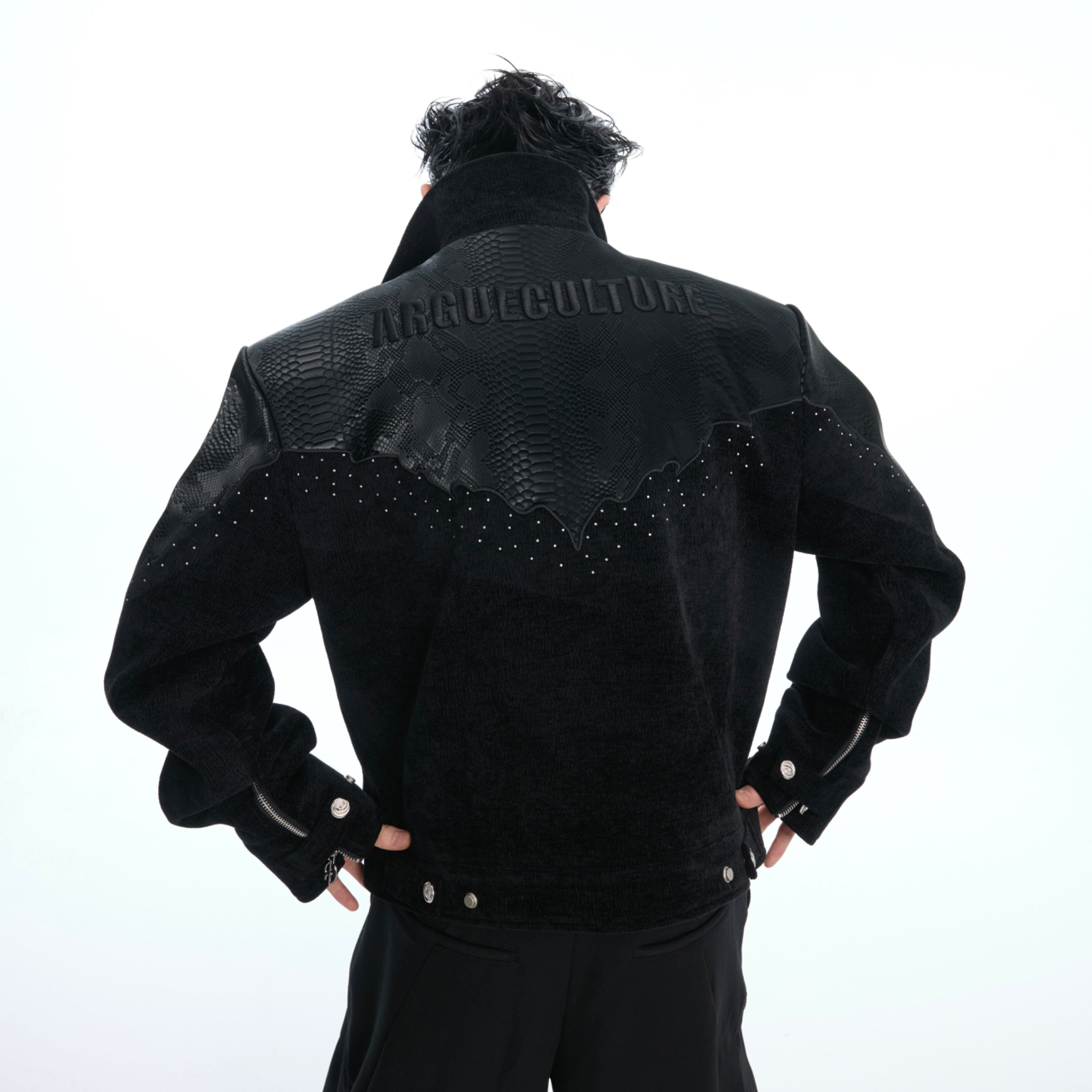 Front view of croc-embossed oversized bomber jacket featuring custom metal studs and logo zipper