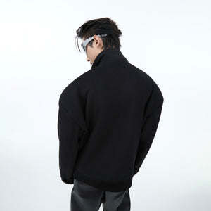 Close-up of unique deconstructed lapel design on cropped wool blazer for fashionable men