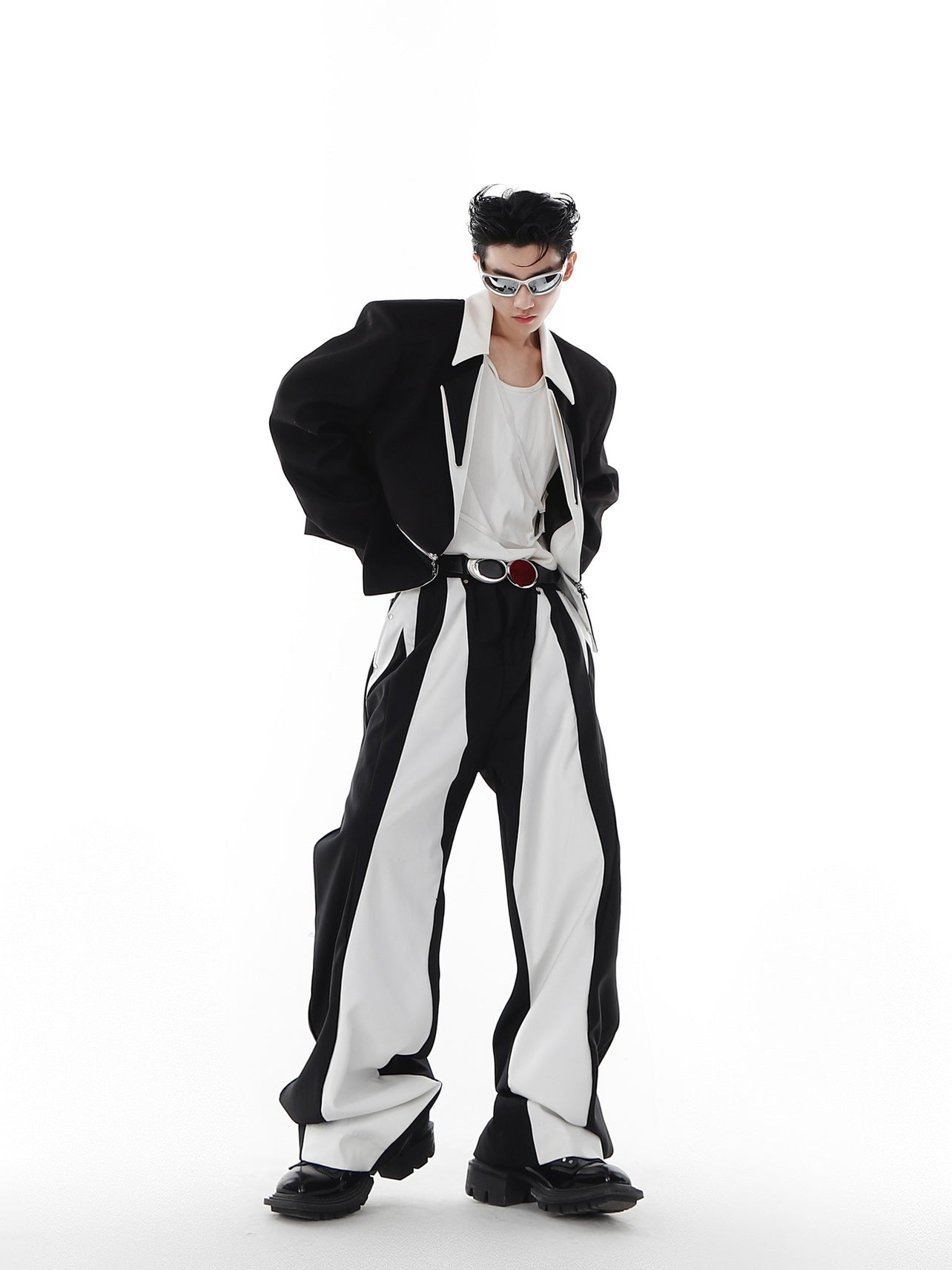 Close-up of deconstructed blazer showing asymmetrical hem and unique cropped silhouette for fashion-forward styling