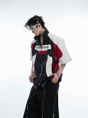 Front view of bold color block cropped leather jacket with deconstructed streetwear style