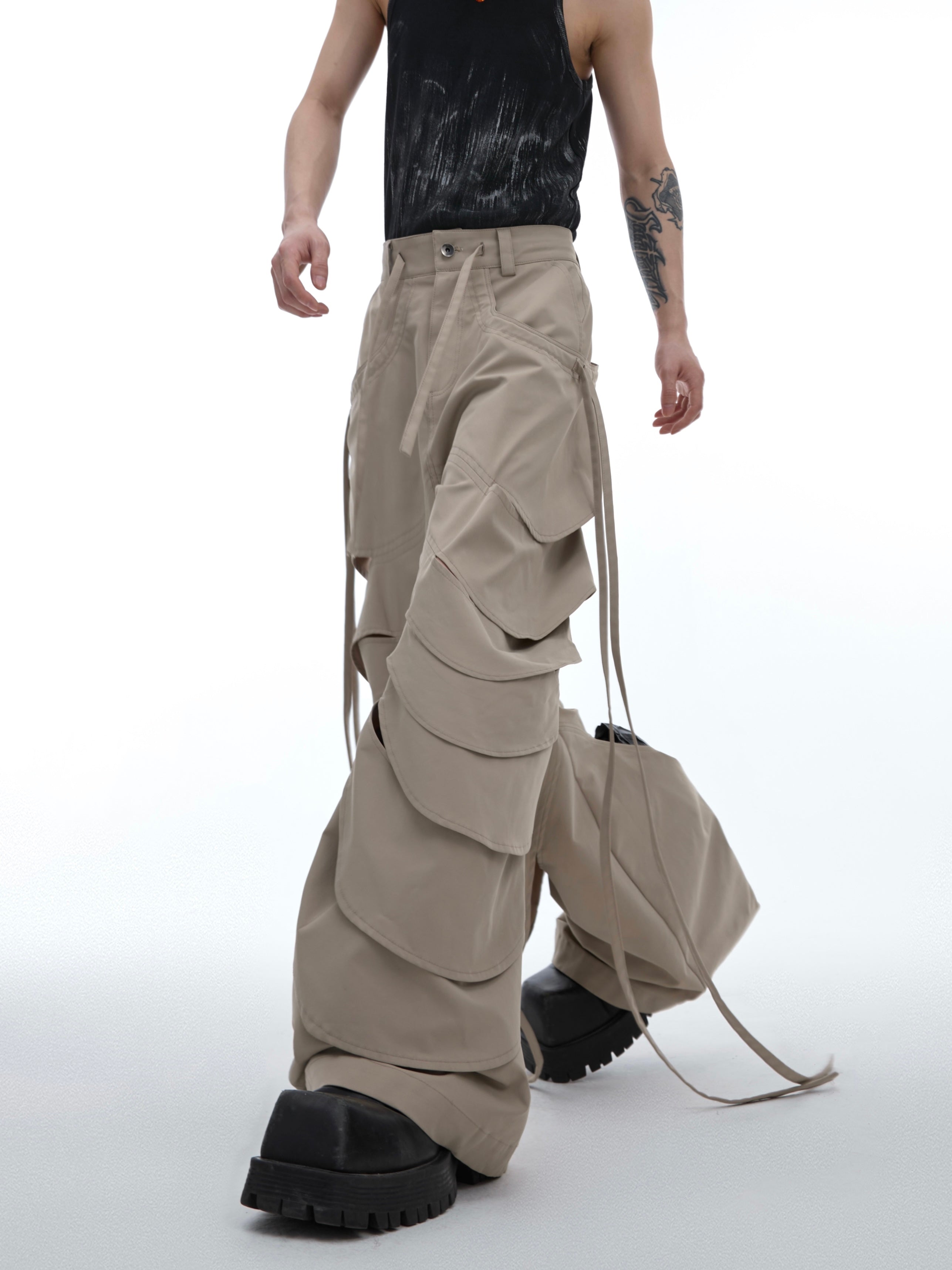 Back view of distressed cargo pants with flared hem and deconstructed cutout design for edgy urban style