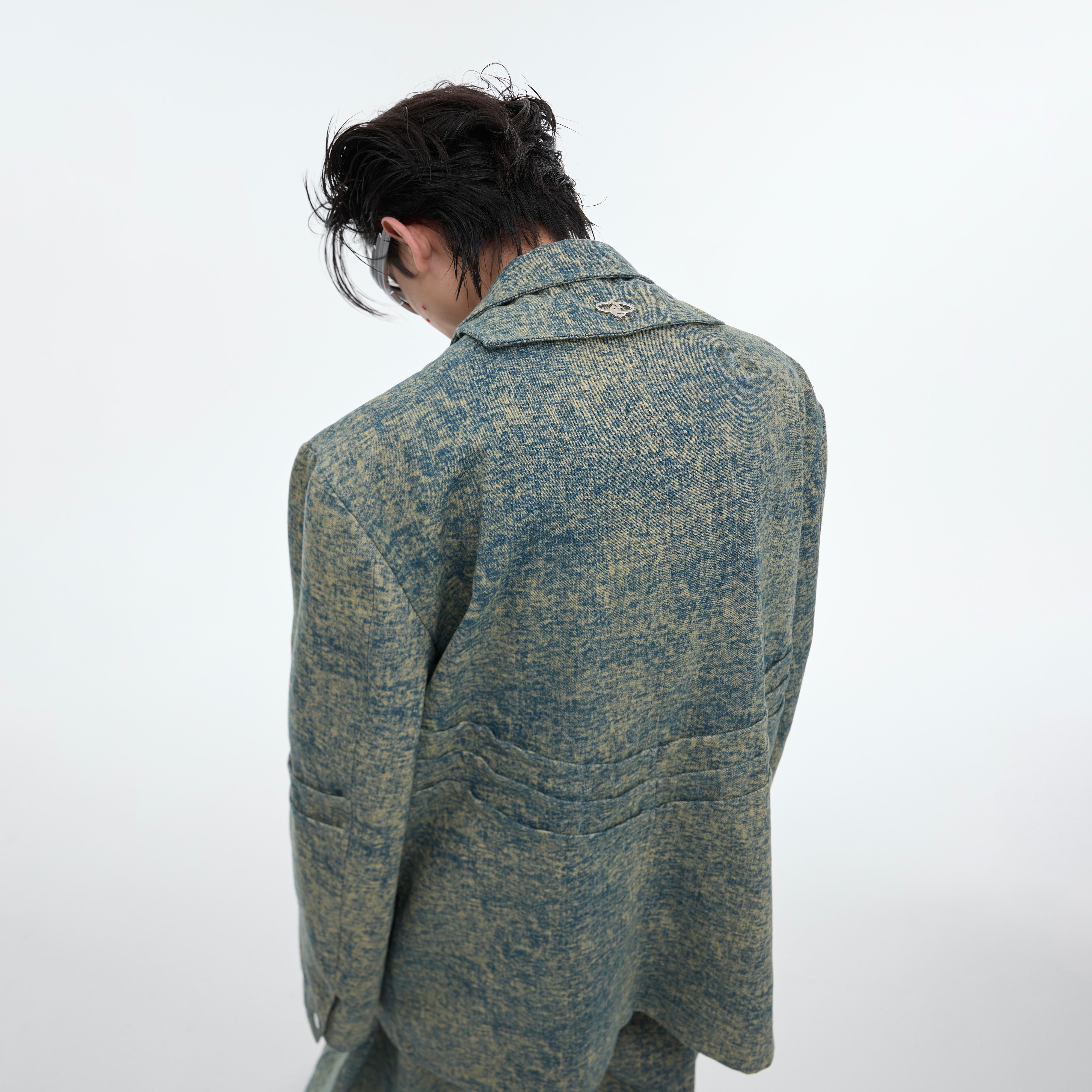 Back view of unique denim blazer jacket showing distressed texture and punk-inspired deconstructed design