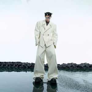 Front view of oversized deconstructed blazer with striking metal buttons and asymmetrical design