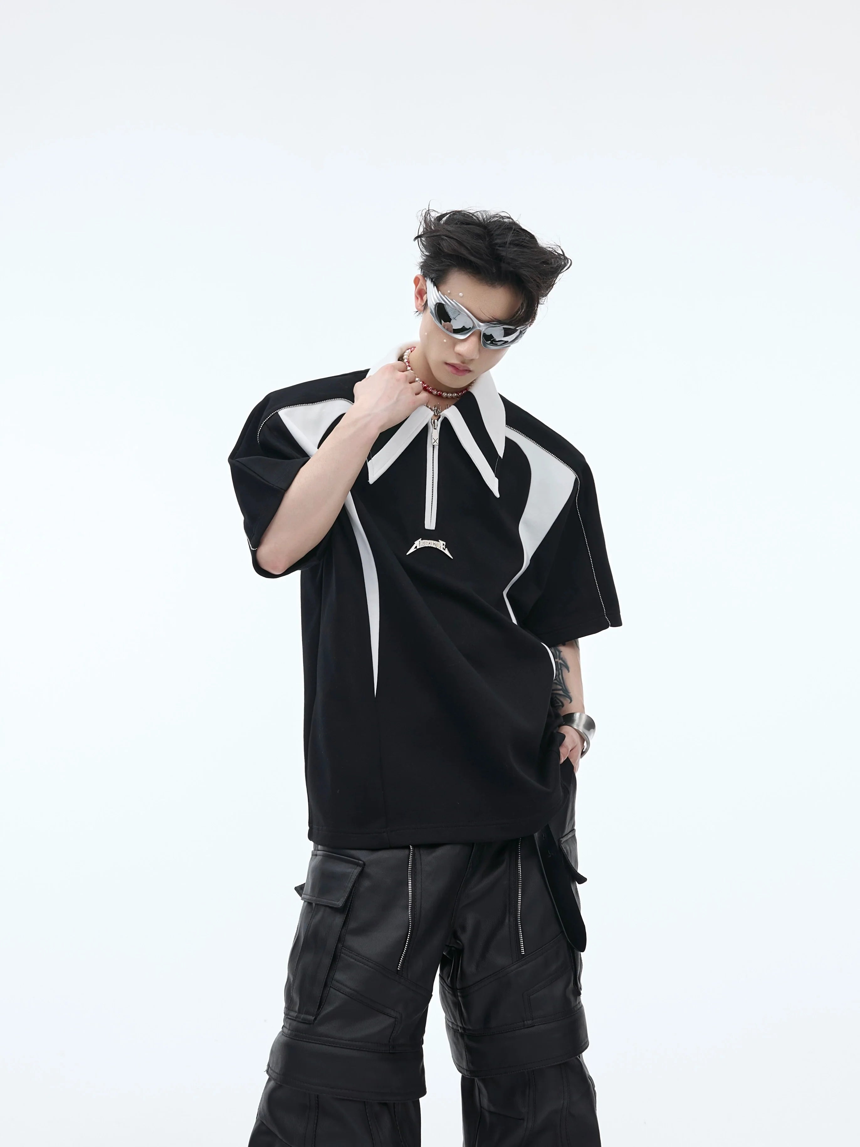 Front view of deconstructed polo shirt with unique color-block design and metal trim detailing on oversized tee