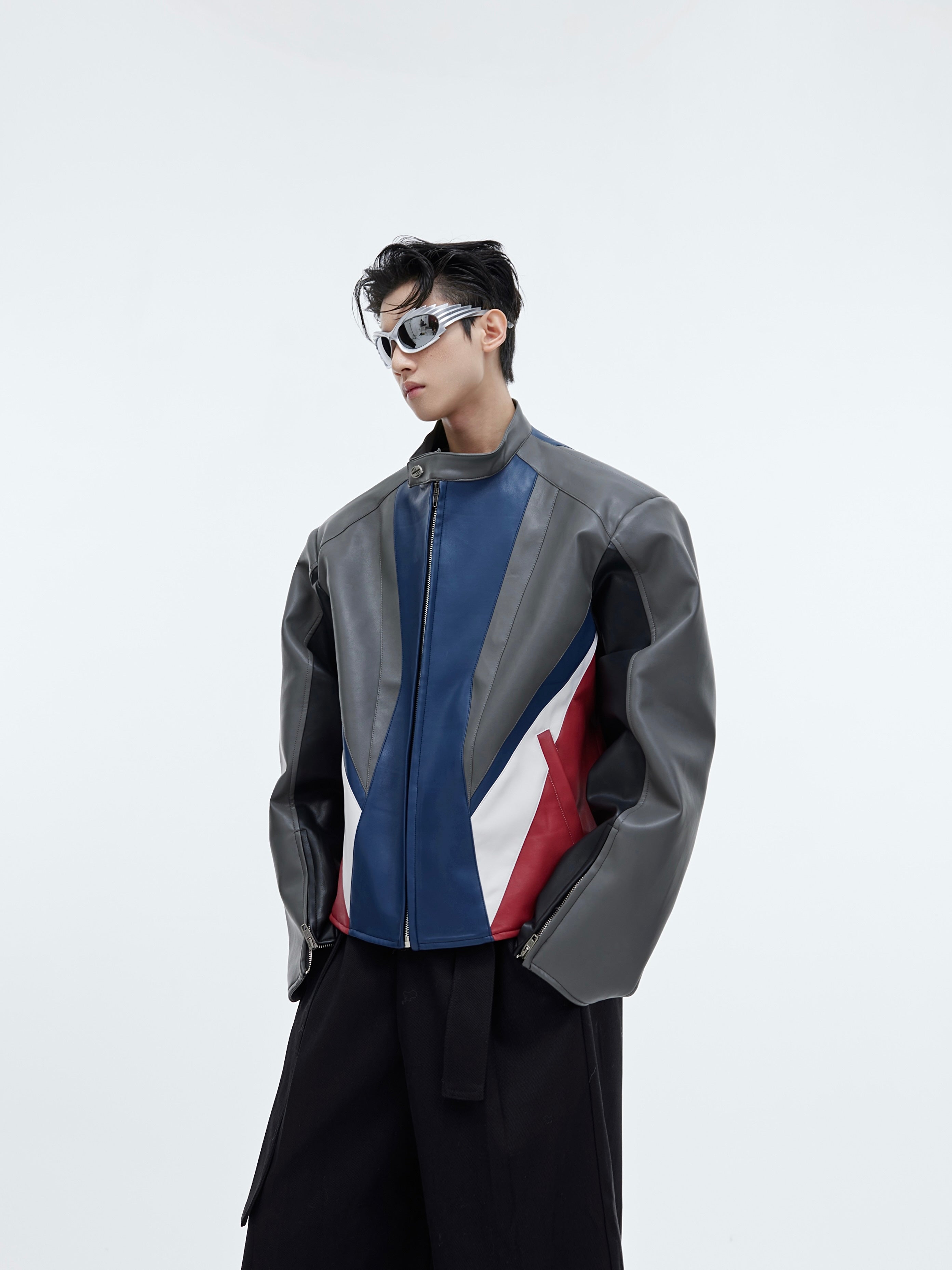 Deconstructed color-block PU leather biker jacket with oversized shoulders, cropped fit and bold panel design for streetwear fashion