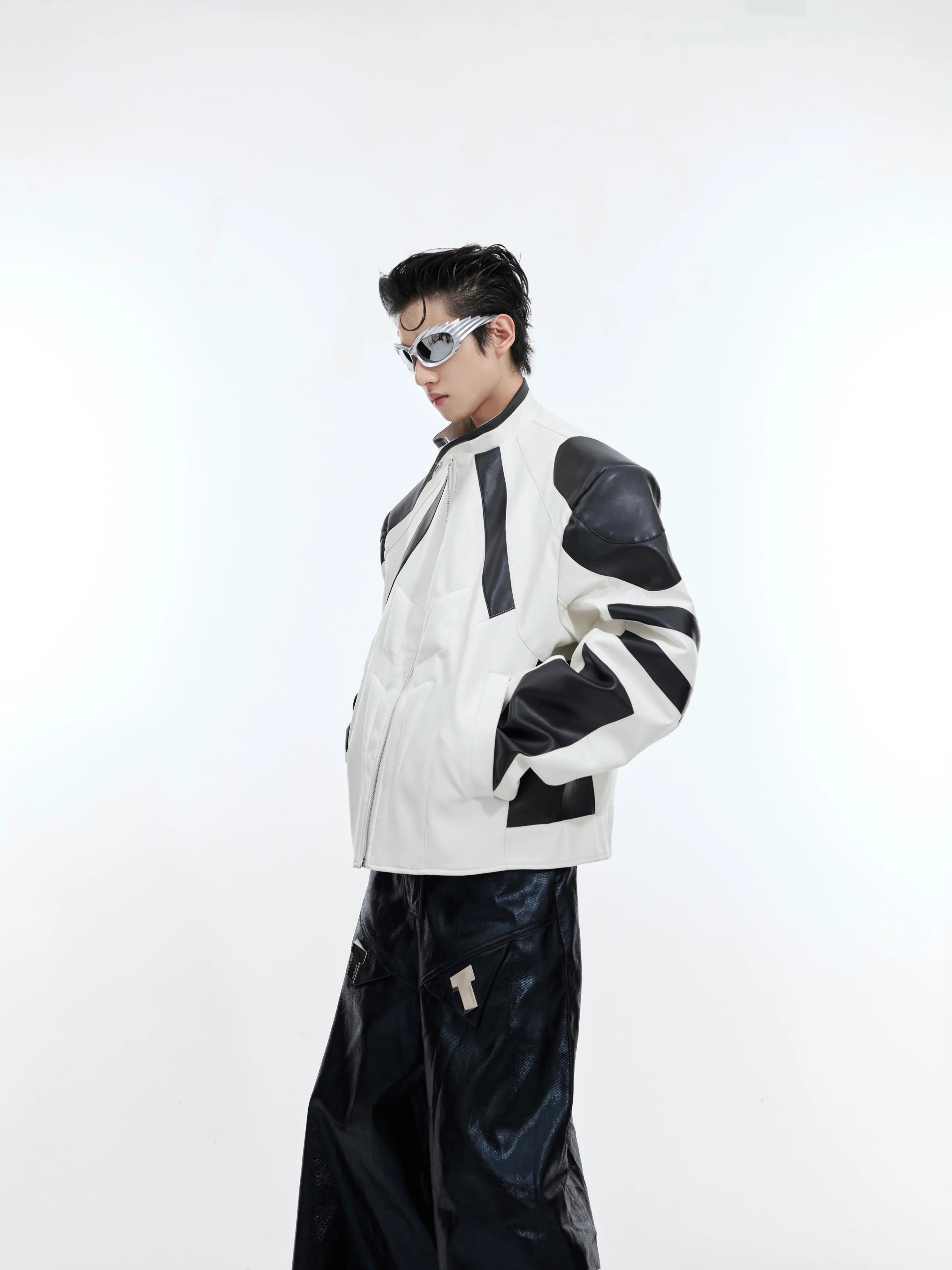 Front view of deconstructed color-block leather jacket showing unique patchwork design and 3D detailing