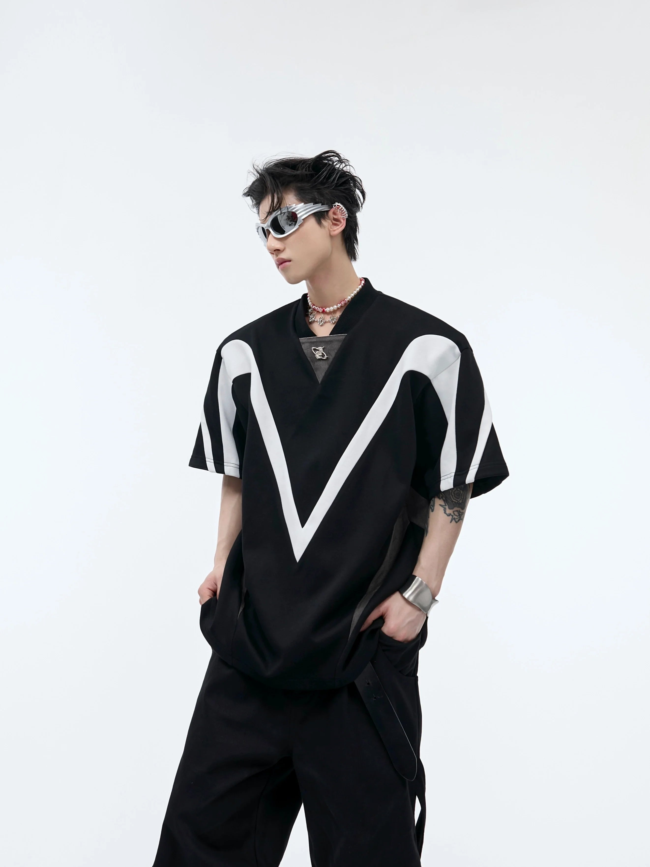 Front view of oversized deconstructed sleeveless tee with bold color-block stripes and raw-edge detailing for urban streetwear