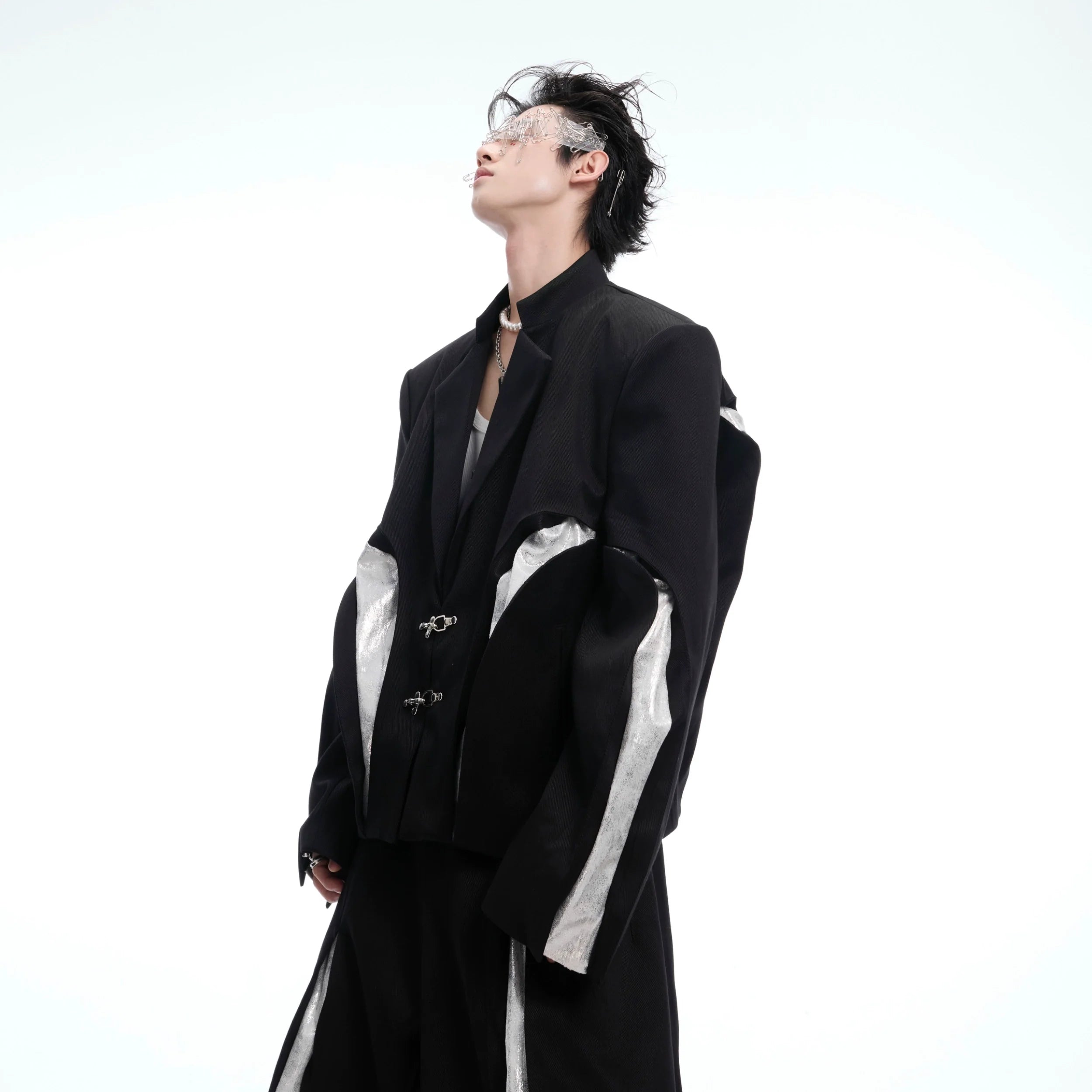 Front view of deconstructed cropped blazer featuring textured twill fabric and metal buttons, perfect for urban streetwear