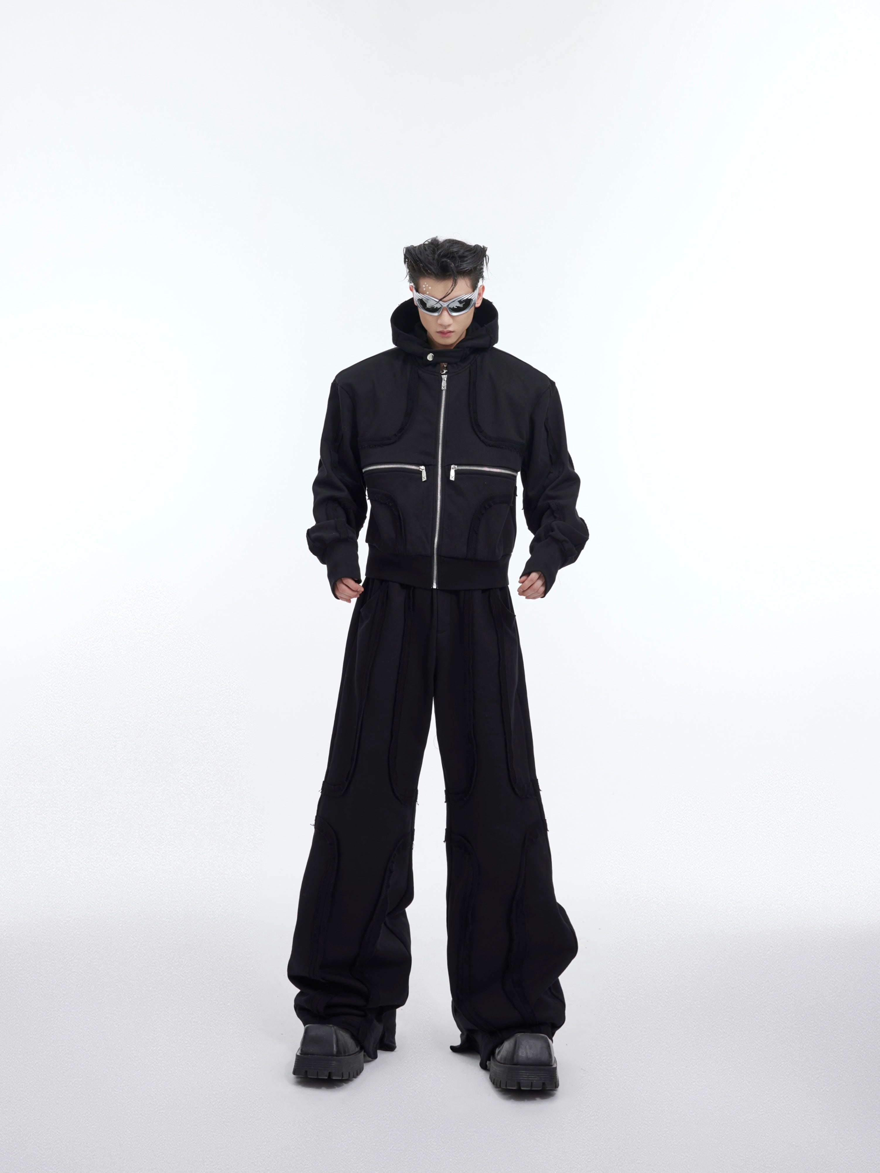 Distressed red cropped hoodie with deconstructed design, showcasing urban streetwear style with raw edge details