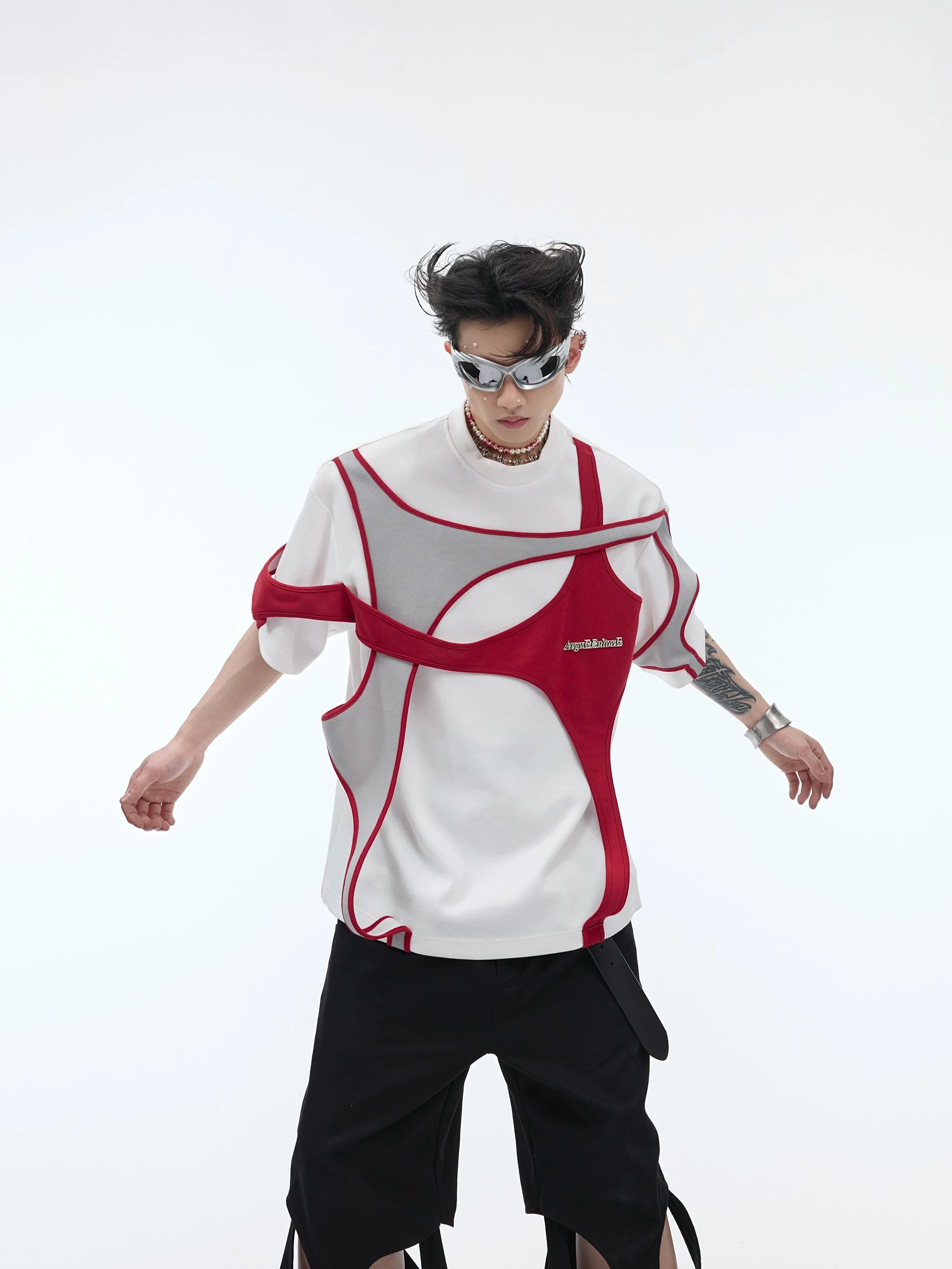 Deconstructed double-layer sleeveless tee with asymmetrical panels and punk-inspired stud detailing, oversized streetwear style