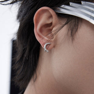 Fashion model wearing avant-garde lava design T-earrings that make a bold jewelry statement