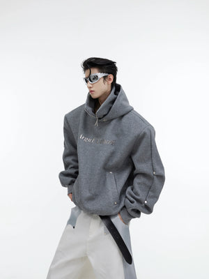 Front view of deconstructed glitter hoodie with high neck and metal buttons, showcasing street-ready style