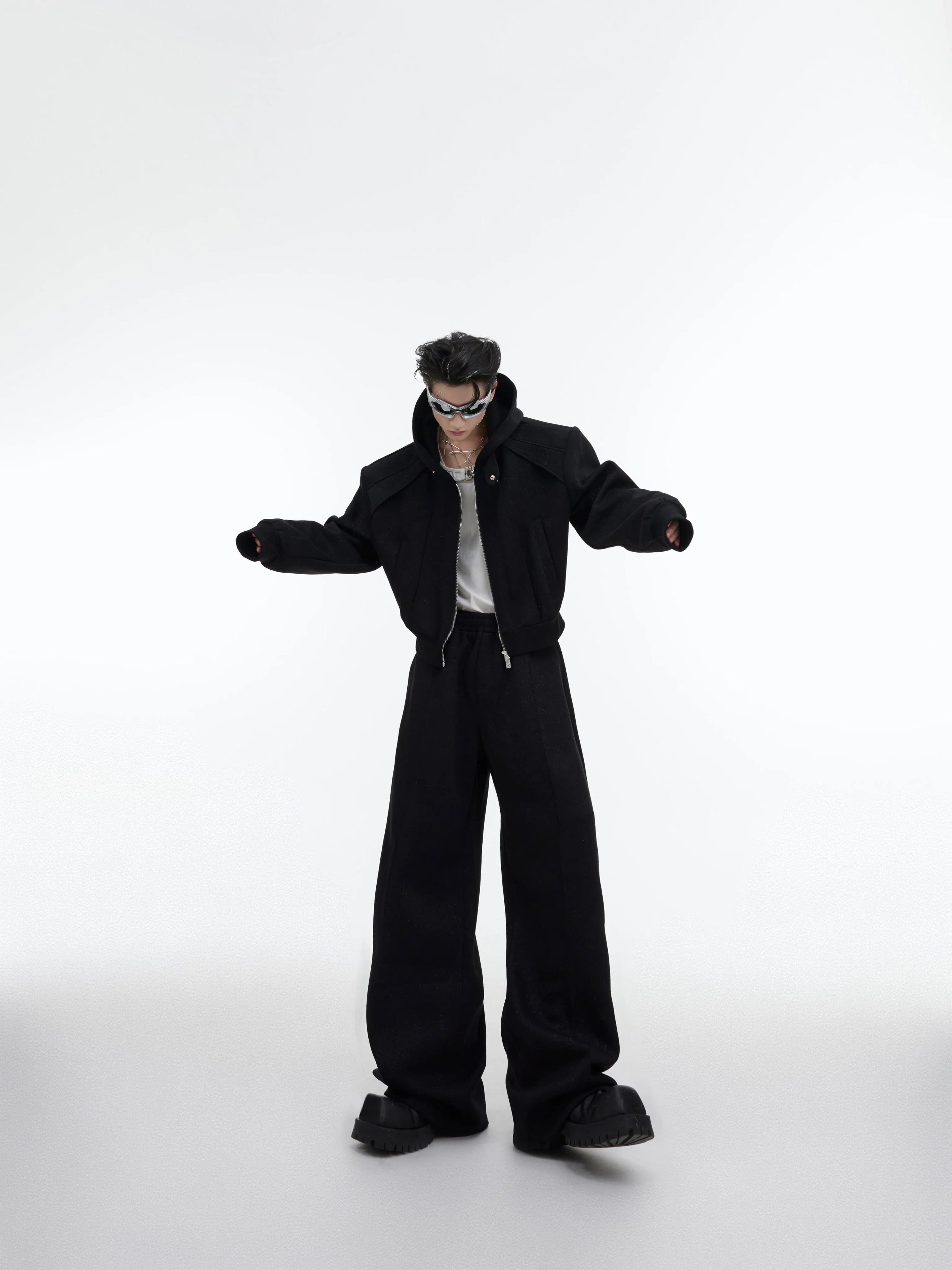 Front view of cropped hoodie with metallic zipper detail from deconstructed hoodie set, showing glitter fabric texture