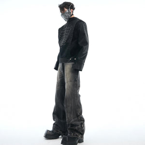 Back view of deconstructed jeans highlighting the gray washed denim and artistic distressing techniques