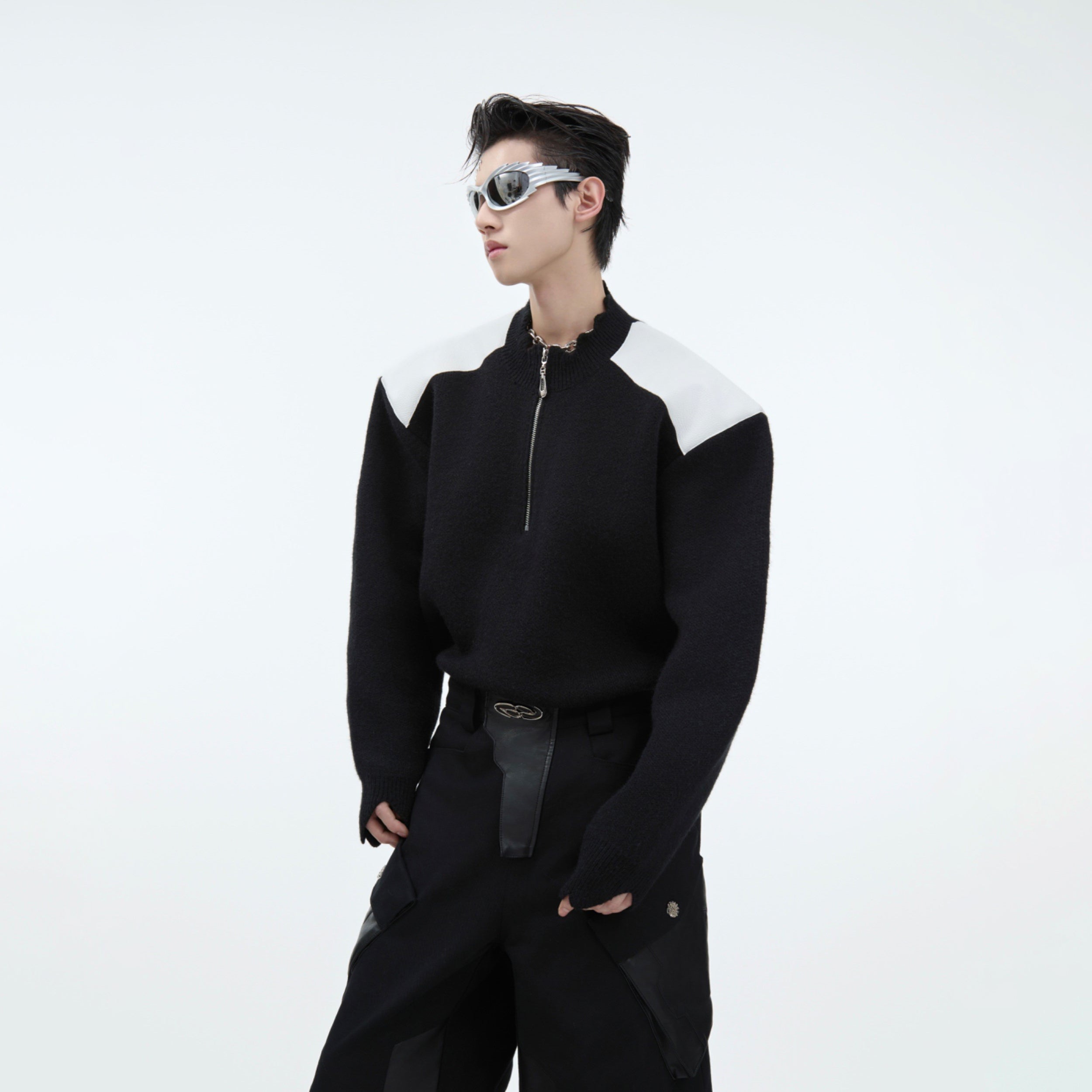 Deconstructed knit sweater with metal zipper detail, showcasing winter streetwear fashion with unique contrast design
