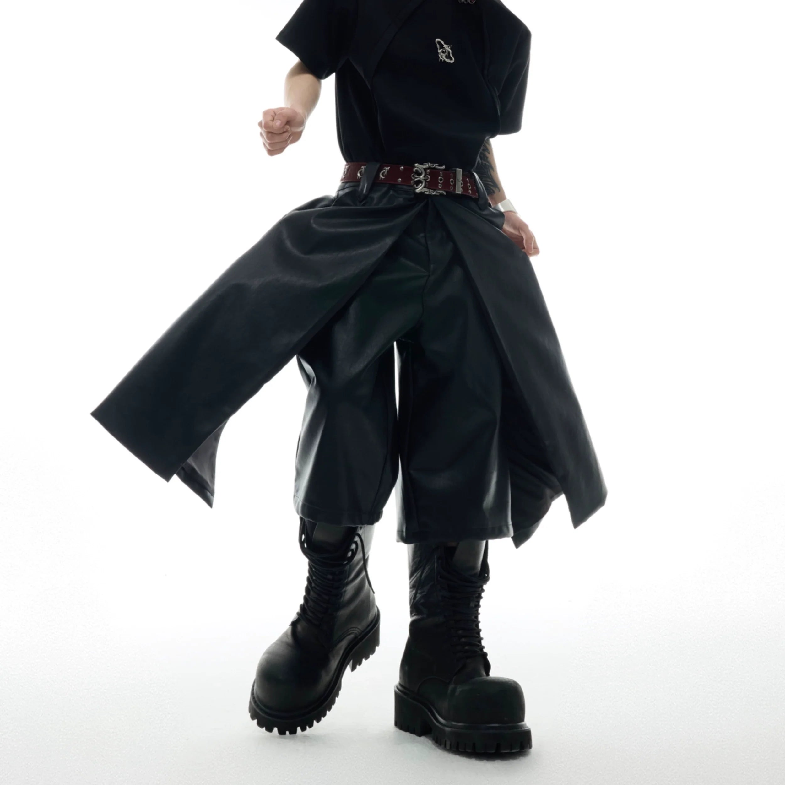 Front view of deconstructed leather shorts showing unique double-layer edge design and loose fit for streetwear fashion