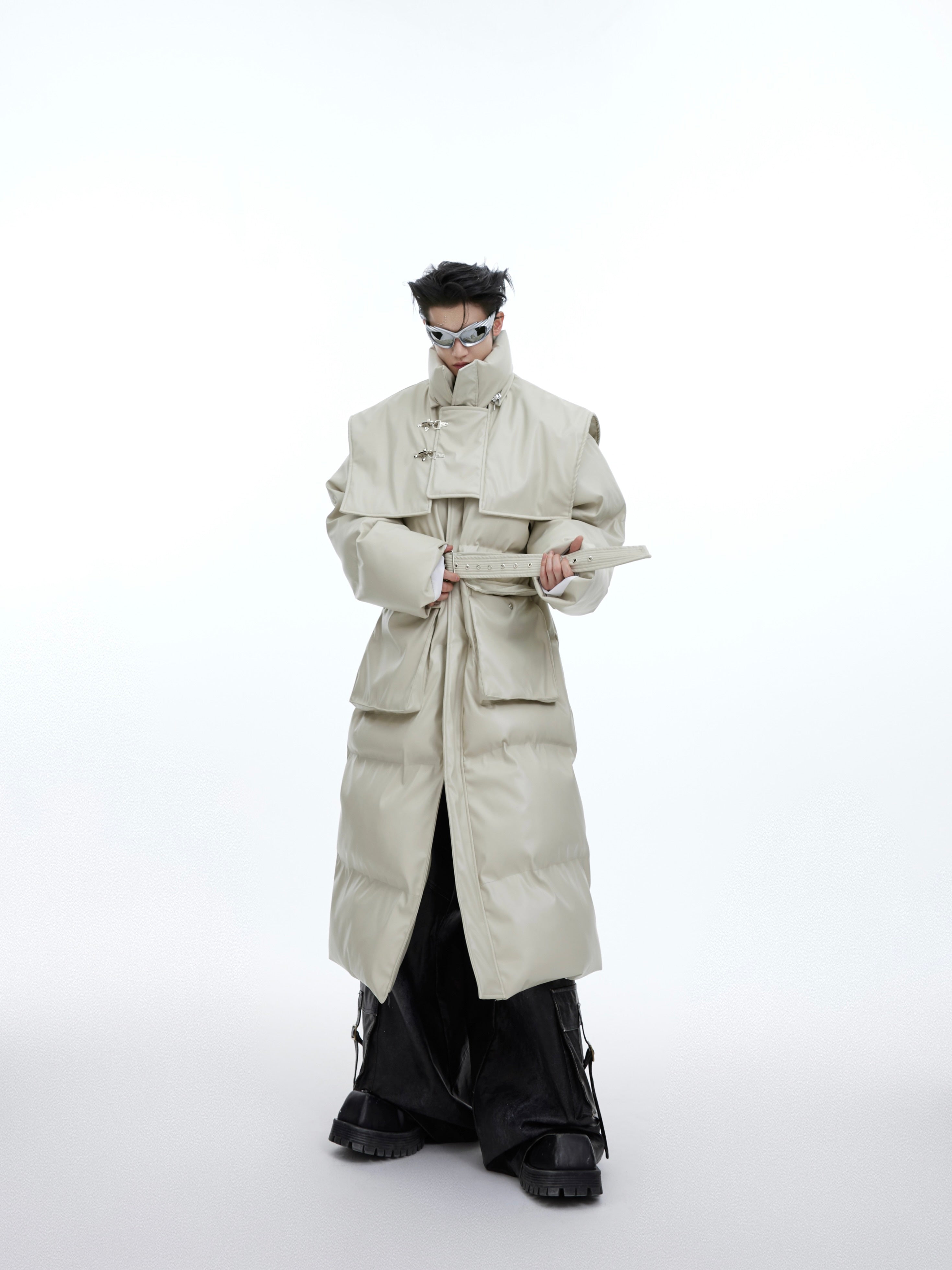 Oversized deconstructed hooded coat showing dramatic angular lines and 3D modular construction for avant-garde streetwear