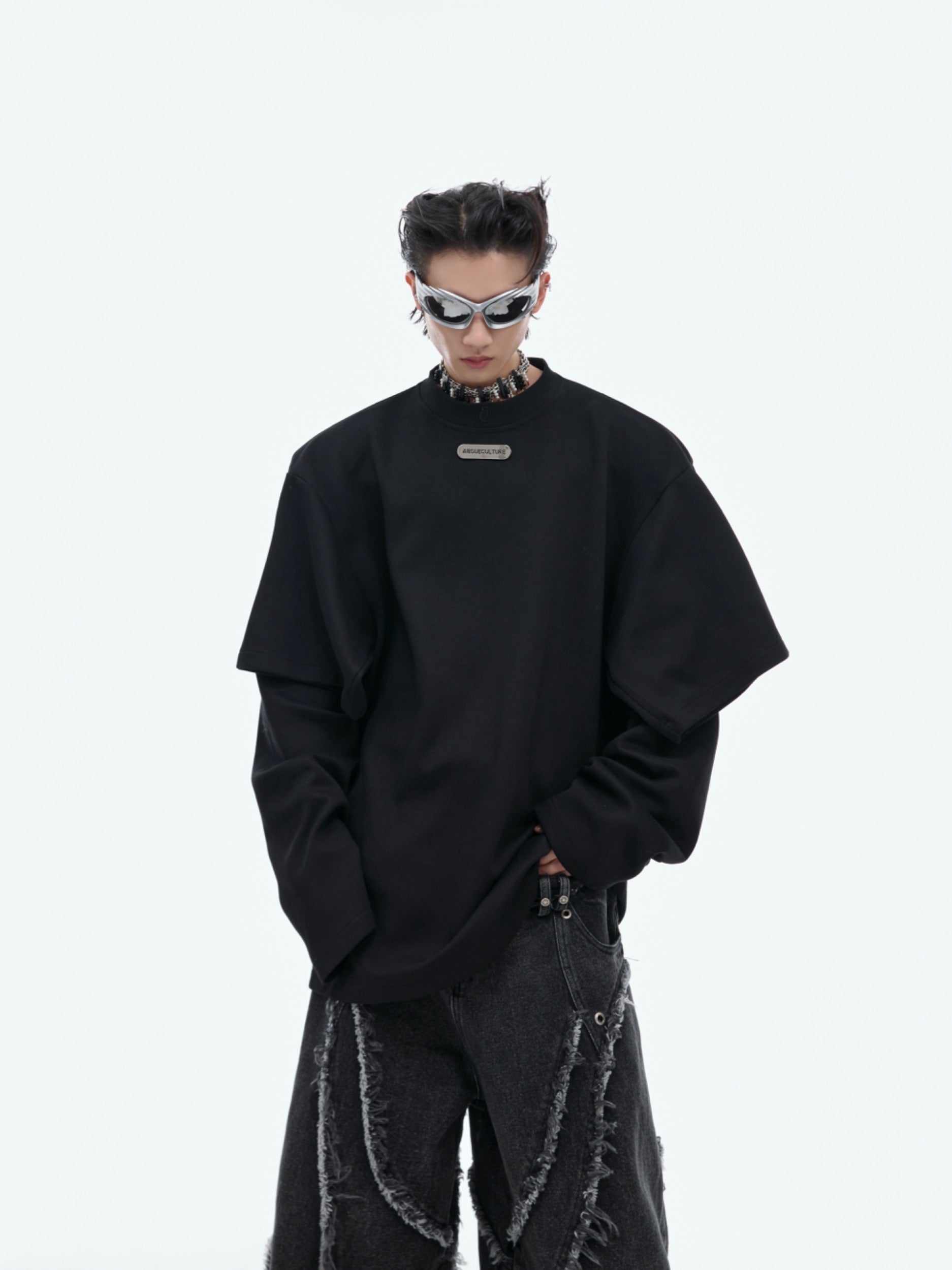 Front view of avant-garde deconstructed oversized hoodie featuring asymmetric cuts and drop-shoulder design for urban streetwear