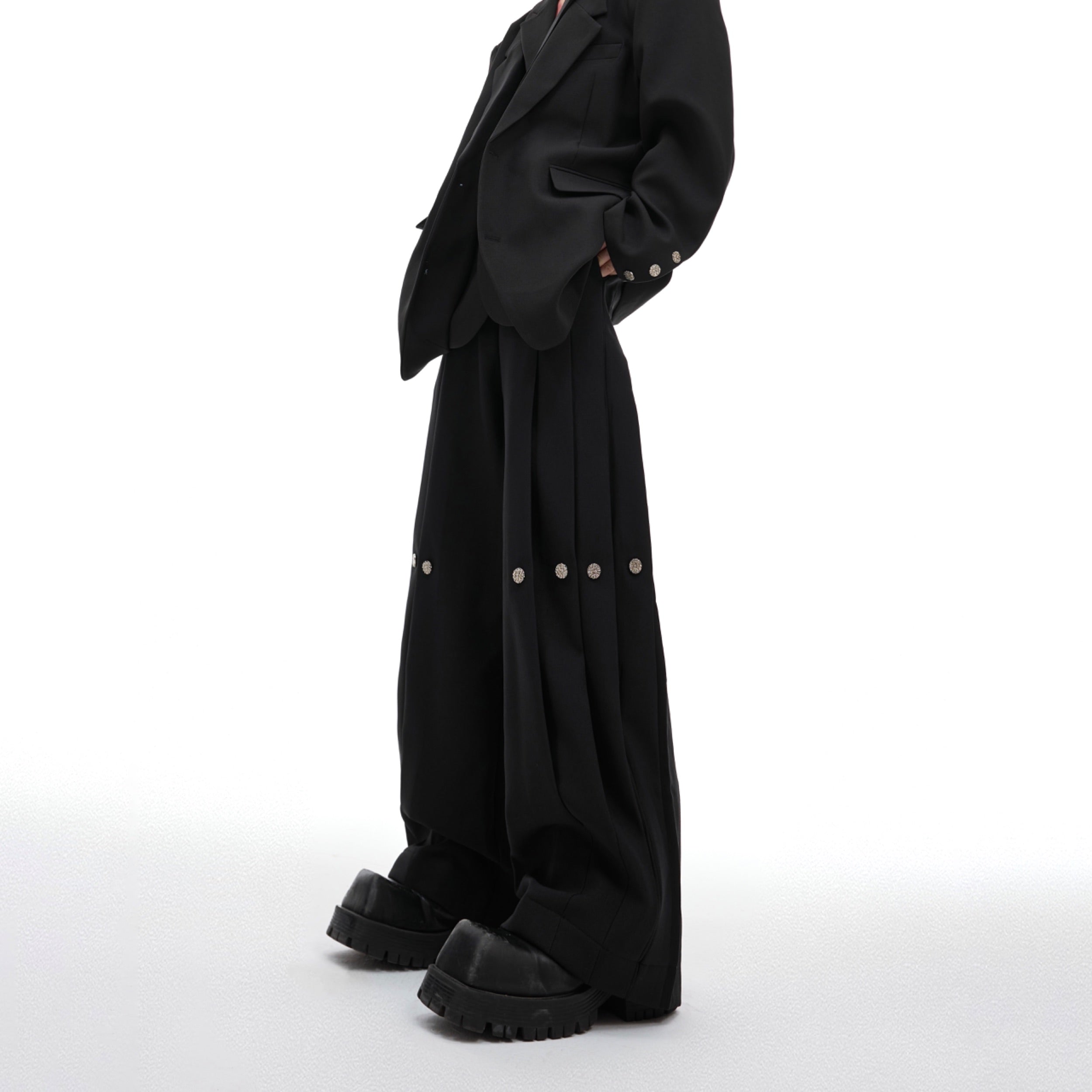 Deconstructed pleated wide-leg trousers featuring asymmetrical paneling for a modern streetwear look