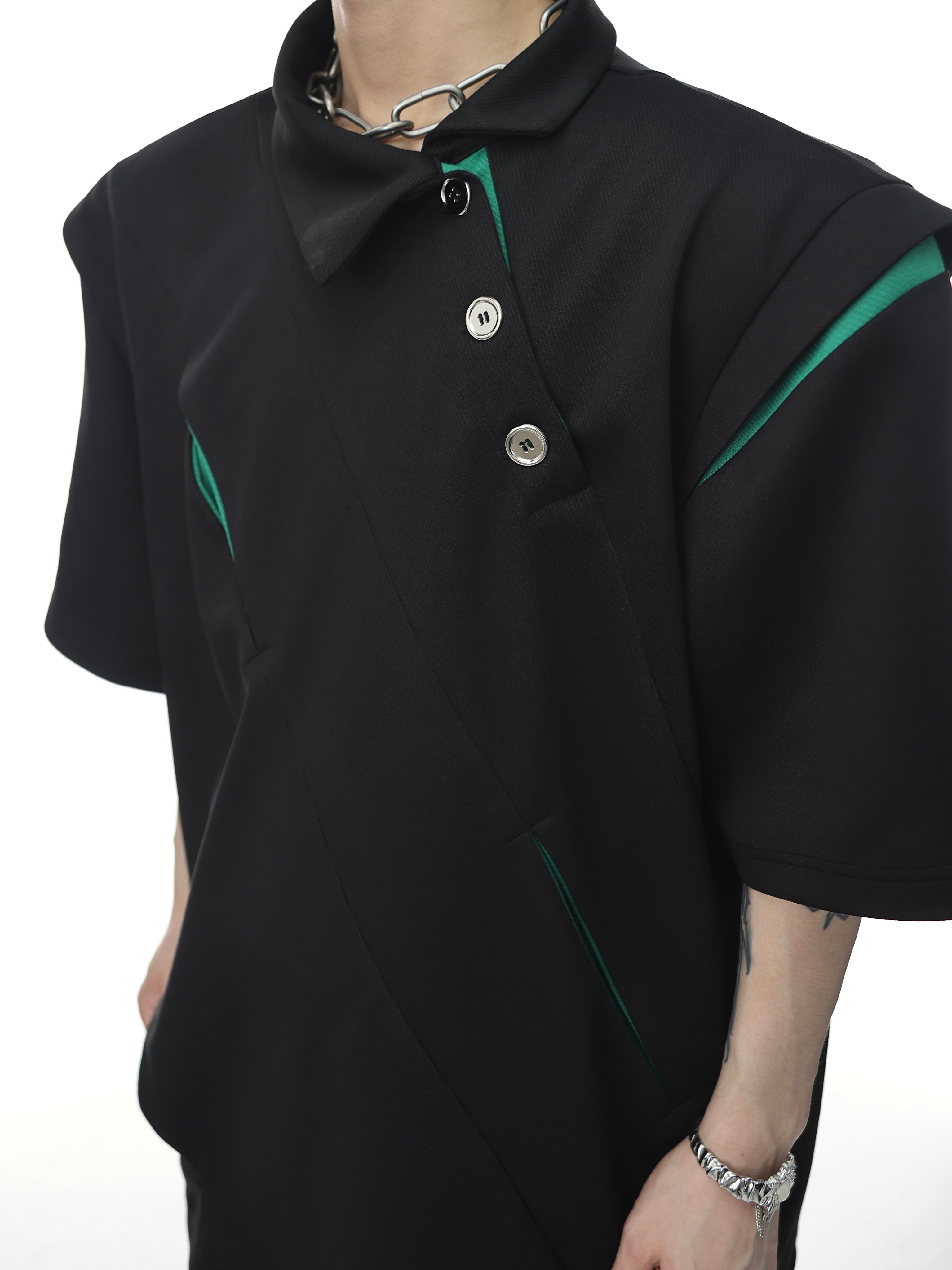 Side angle showing color-block design and razor-sharp tailoring of this reconstructed polo shirt