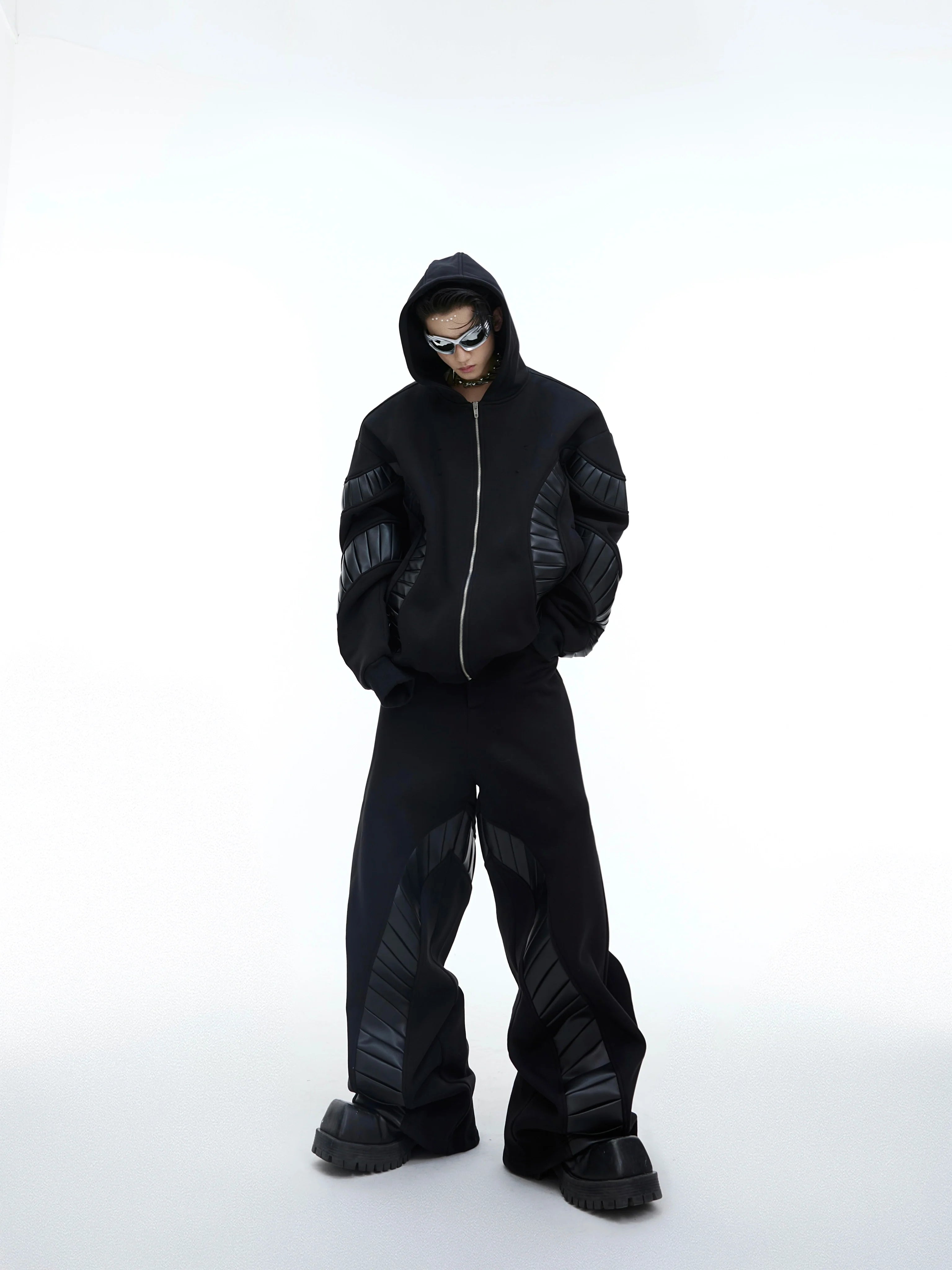 Front view of deconstructed PU patch hoodie with fleece lining, showing oversized streetwear silhouette and ribbed details