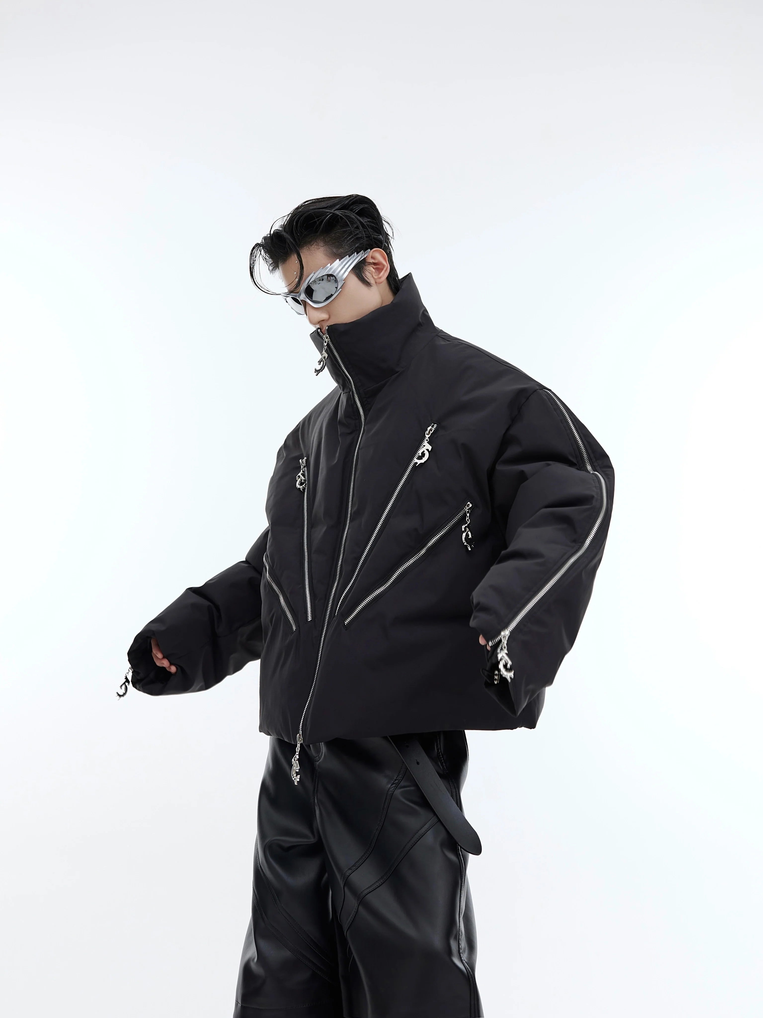 Front view of cropped puffer jacket with multiple symmetrical zippers, showcasing urban streetwear style with deconstructed design