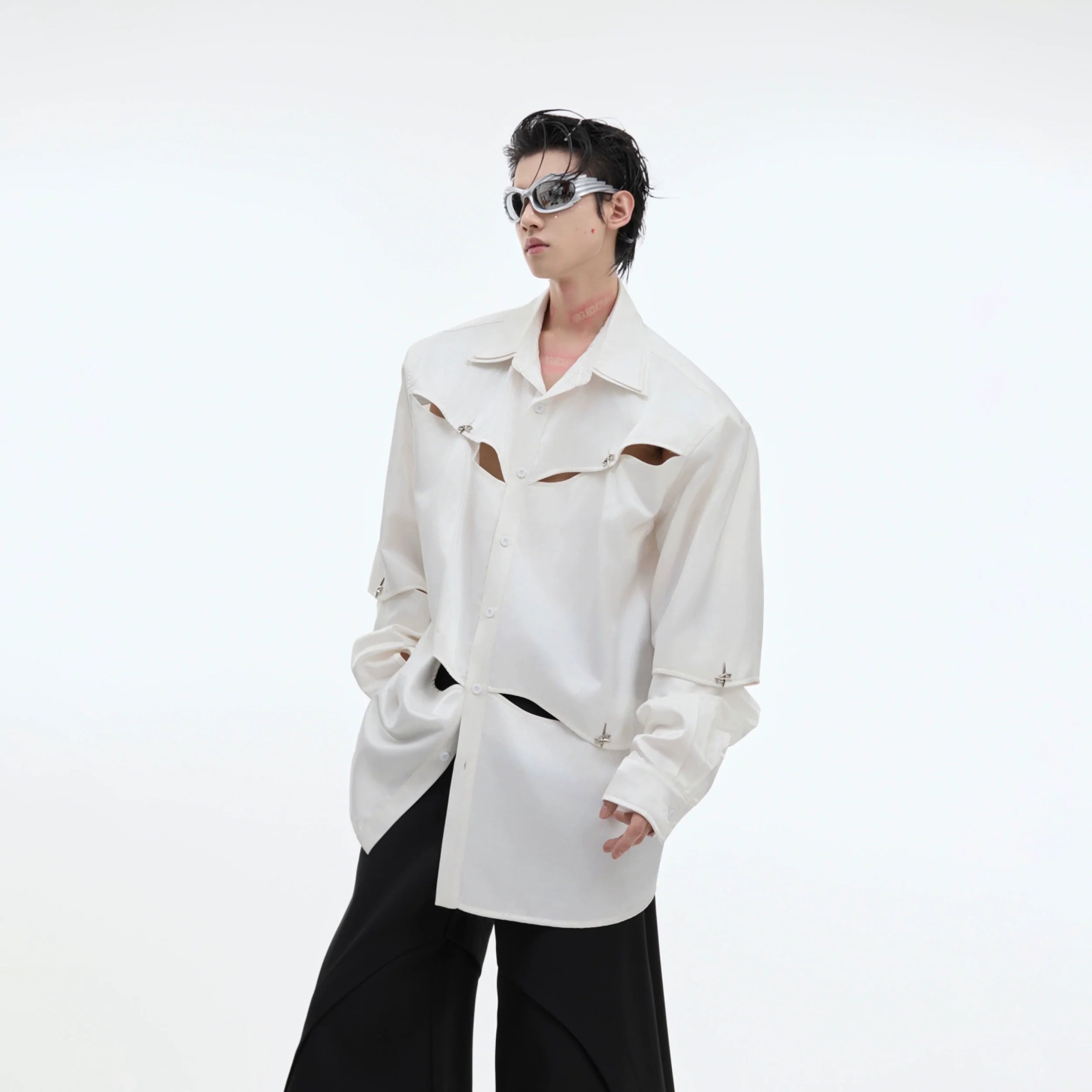 Front view of deconstructed oversized shirt with removable sleeves, showcasing avant-garde streetwear design and asymmetric tailoring
