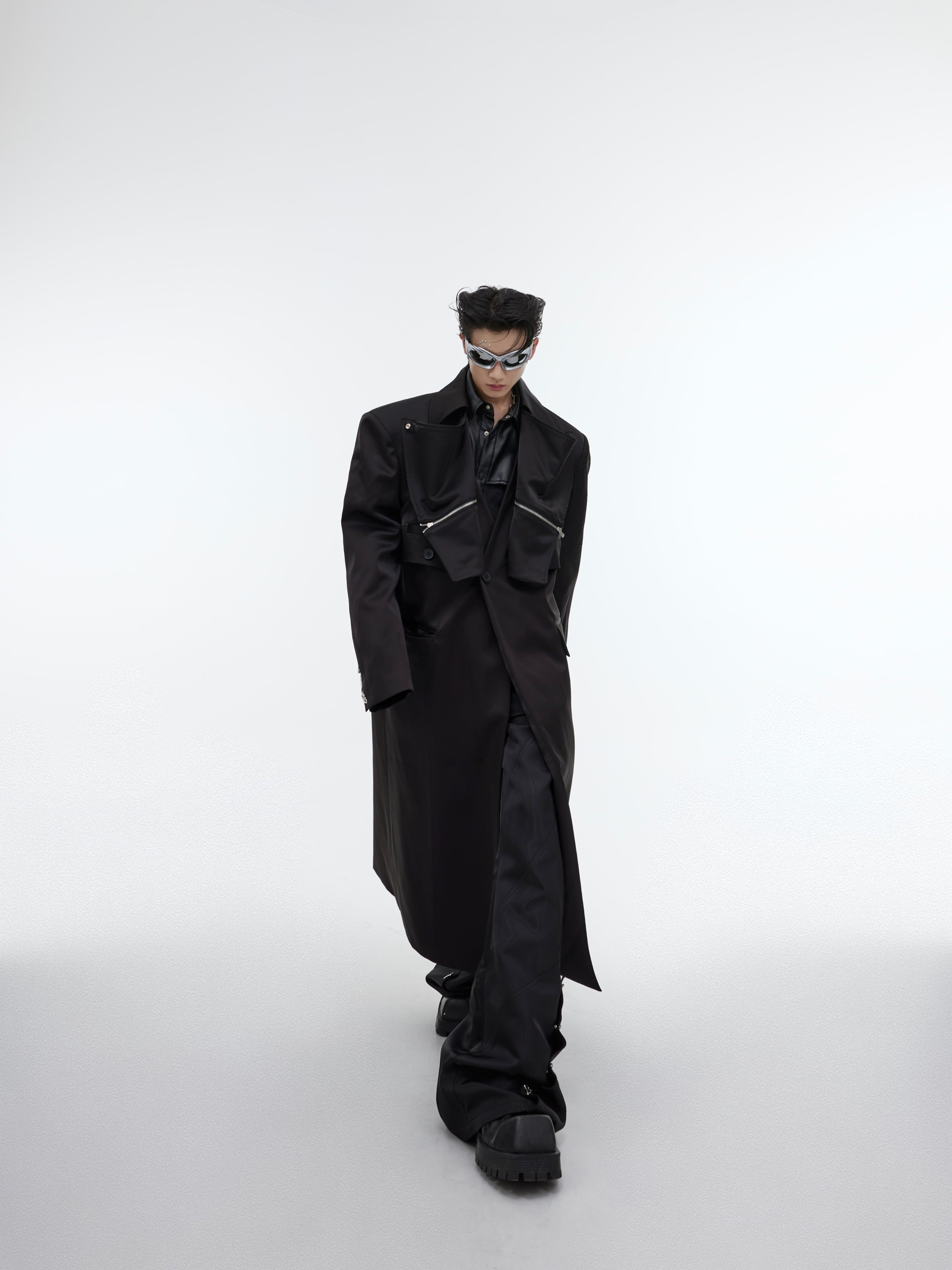 Deconstructed long trench coat with metallic accents and double-layer construction, perfect for urban streetwear looks