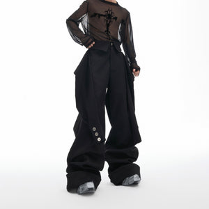 Streetwear pants with deconstructed sleeve details and prominent metal buckle accents, relaxed fit for urban fashion