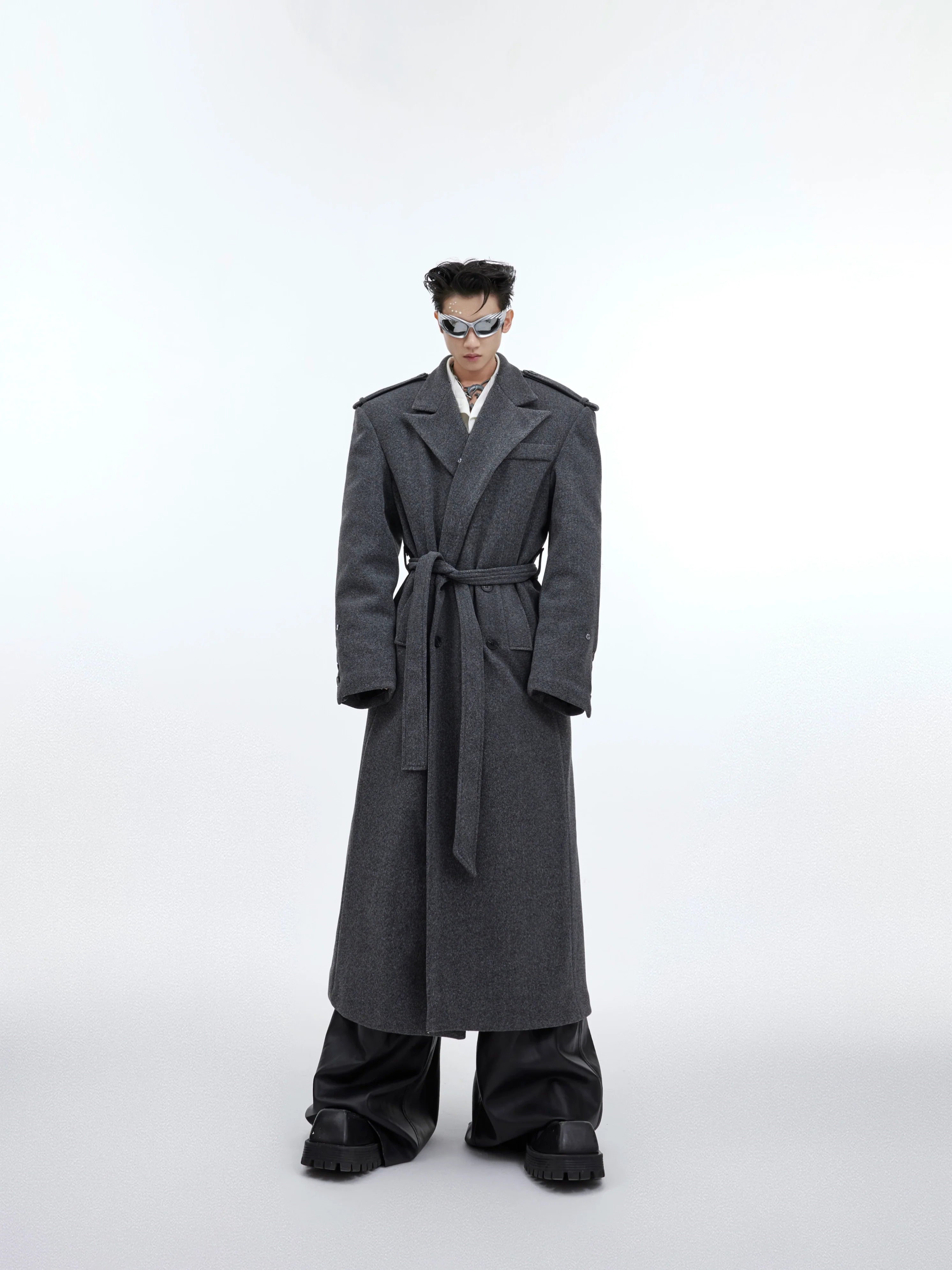 Oversized long wool overcoat with belt showcasing avant-garde tailoring and architectural silhouette