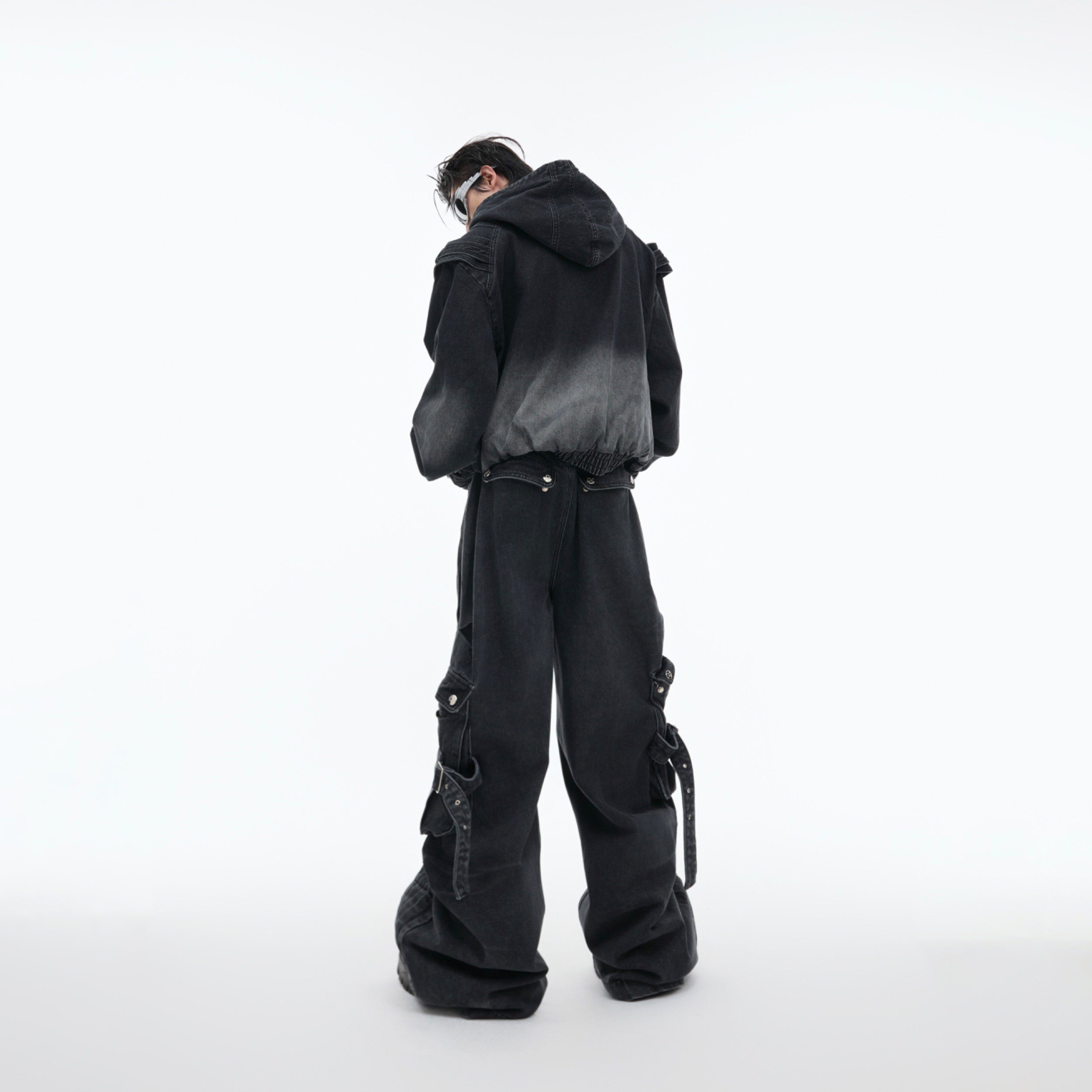 Close-up of deconstructed denim jacket featuring removable shoulder pads for punk-inspired styling