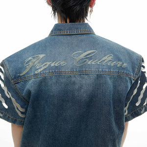 Back view of fashion-forward denim jacket featuring bold stand-up collar and overlapping shadow design