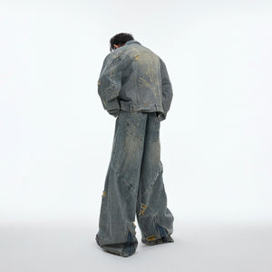 Full denim suit set showing asymmetrical distressing and shoulder pad design with post-apocalyptic aesthetic