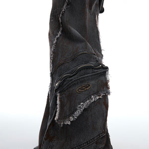 Back view of avant-garde denim jacket showing distressed texture and raw edge construction
