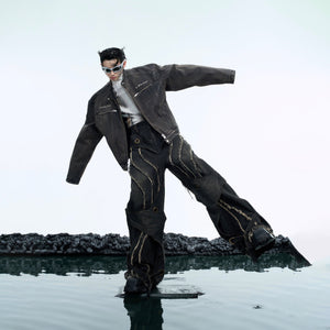 Close-up of distressed denim texture showing the raw edges and double-layer construction details