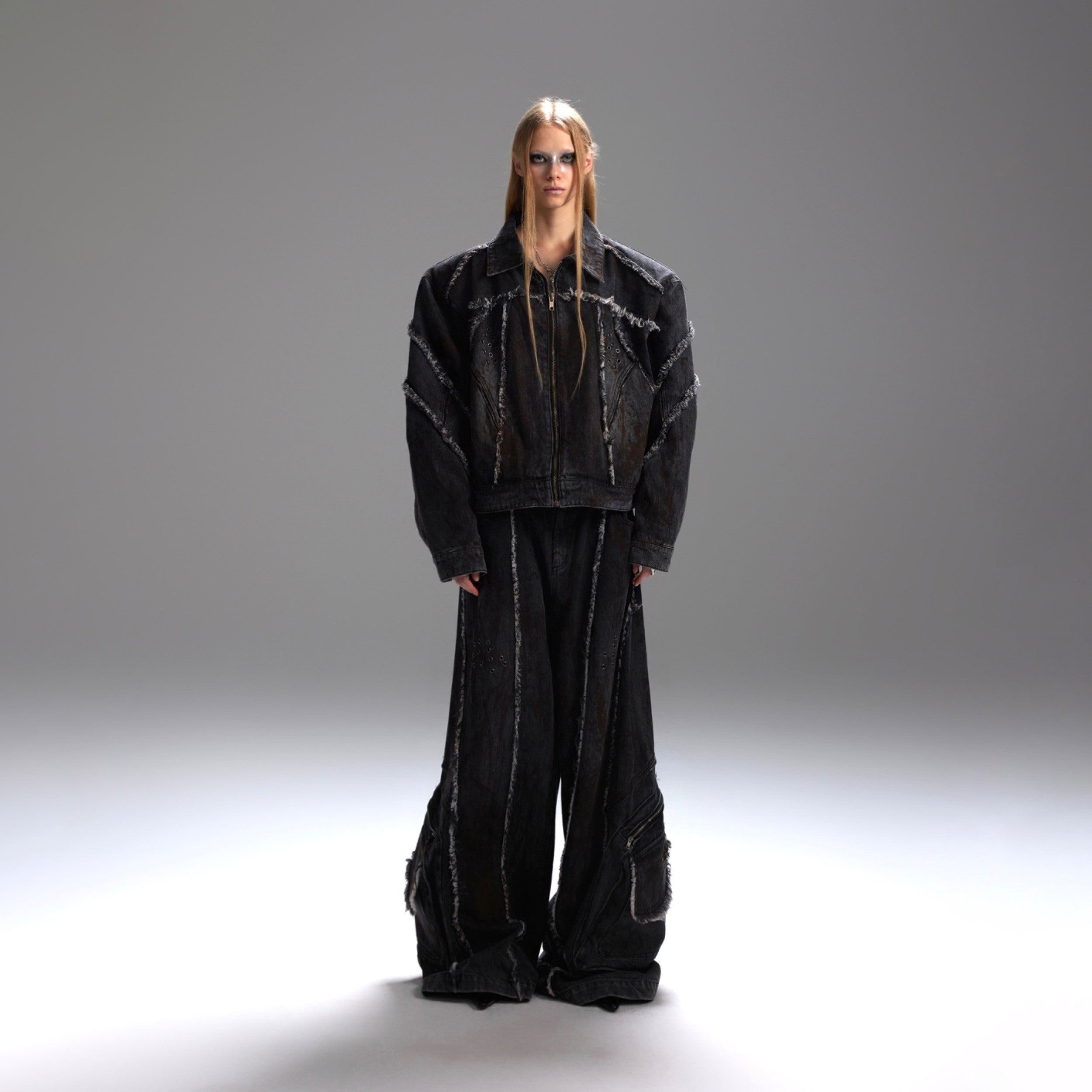 Front view of distressed denim jacket with 3D cut pockets and raw hem detailing, oversized streetwear style