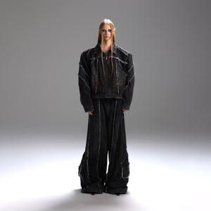 Front view of distressed denim jacket with 3D cut pockets and raw hem detailing, oversized streetwear style